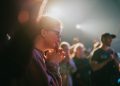 selective focus photography of woman praying